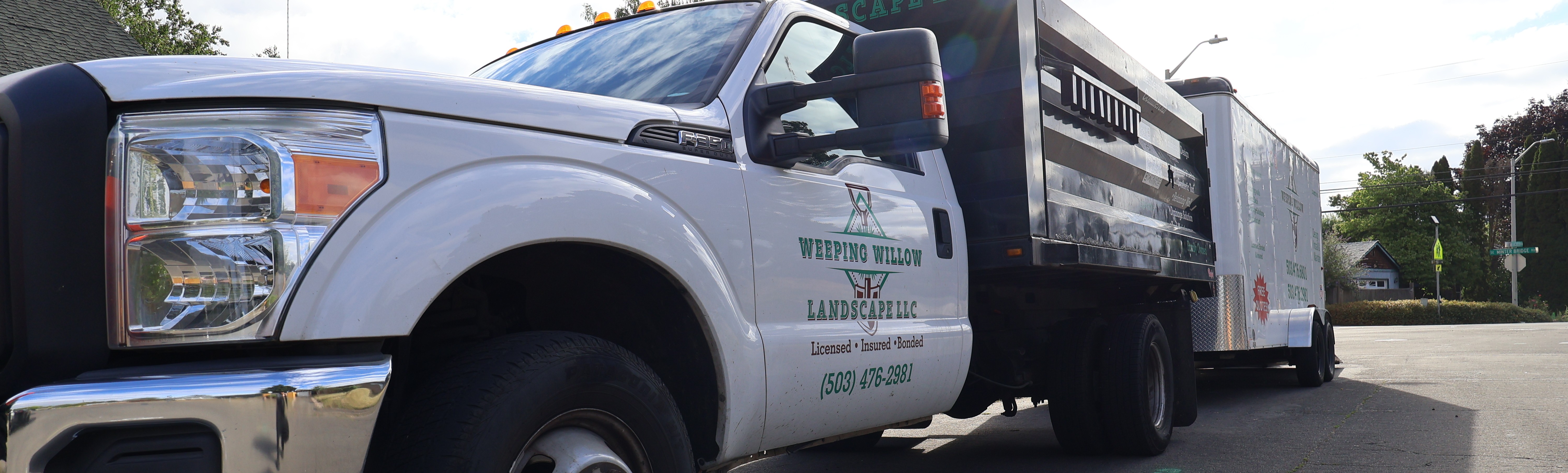 Weeping Willow Landscape truck and enclosed trailer ready for landscaping, fencing, and hardscape work in Washington County